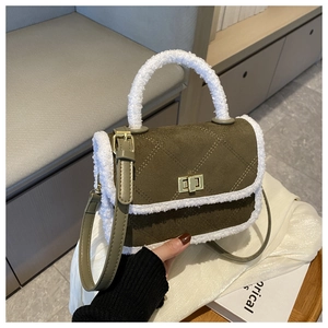 Close-up of olive green quilted suede bag with soft white faux fur trim and gold lock