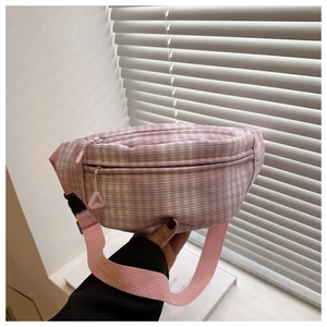 Detail of pink plaid waist bag with double zippers and adjustable strap for girls