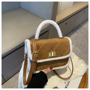Detail of brown quilted bag with white faux shearling trim and golden twist lock