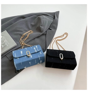 Close-up of denim and black crossbody bags with gold chain straps and frayed edges