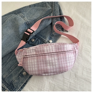 Detail of lavender checkered crescent waist bag with adjustable pink woven strap and buckle