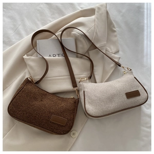 Detailed view of vintage canvas handbags in brown and beige with striped texture