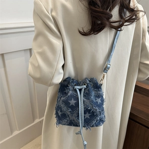 Star pattern denim bucket bag with frayed edges and drawstring closure for women