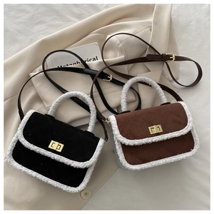 Detail of square suede crossbody bags with white shearling trim and gold twist locks