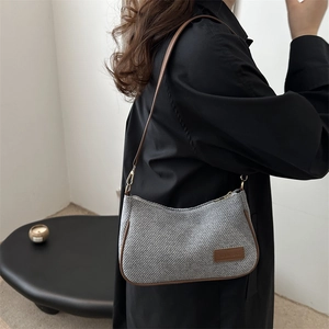 Chic grey woven underarm bag with brown leather trim and slim shoulder strap