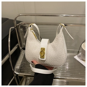 Detail of white woven texture shoulder bag with elegant golden ring metal clasp closure