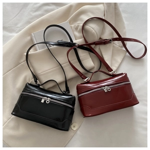 Detail of vintage box bags in black and burgundy faux leather with silver dual zippers