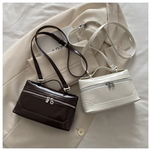 Detail of vintage square crossbody bags in beige and coffee faux leather finish
