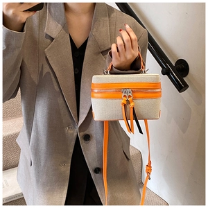 Chic cream canvas and bright orange leather square bag with silver double zipper and handle
