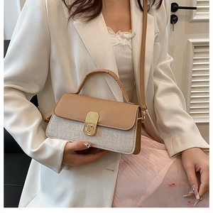 Detail of small square crossbody bag with beige leather and woven fabric texture