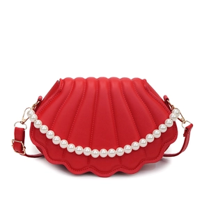Red shell-shaped crossbody bag with pleated texture and decorative pearl chain handle