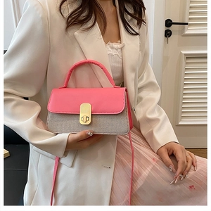 Detail of pink leather flap and woven grid texture on women's chic crossbody bag