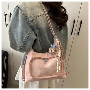 Pink tote bag detail with transparent PVC display pocket and plush charm on the shoulder
