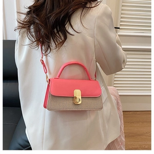 Pink and beige panelled crossbody bag shown on a model in a cozy indoor setting