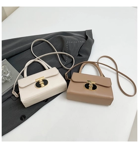 Detailed view of luxury square crossbody bags with golden T-locks in beige and khaki leather