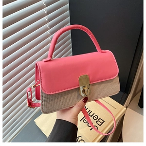 Detail of pink leather and beige woven patchwork bag with a golden turn-lock closure