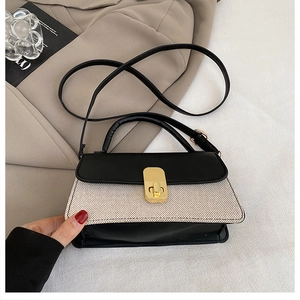 Close-up of the stylish contrast leather handbag with premium gold metal buckle detail