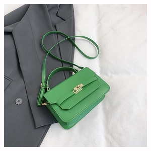 Detailed view of the grass green crossbody bag with a gold metal clasp and adjustable strap