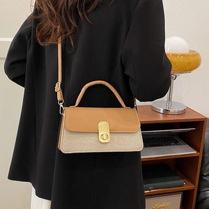 Chic two-tone shoulder bag with brown leather, beige texture, and gold metal lock