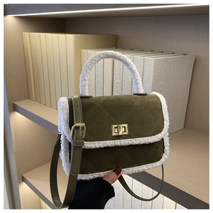 Detail of army green suede bag with lamb wool trim, diamond stitching and gold turn-lock