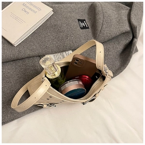 Spacious beige leather shoulder bag showing daily items like phone and cosmetics inside