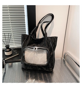 Detail of black pleated tote bag featuring clear PVC front pocket and silver metal zippers