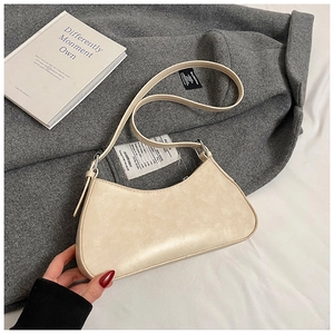 Chic cream faux leather baguette bag shown against a textured grey wool coat background