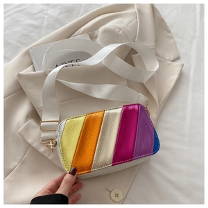 Macro shot of colorful rainbow stripes on pebbled leather camera bag with gold hardware