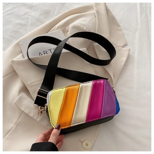 Close-up of rainbow striped crossbody bag with metallic finish and wide nylon strap