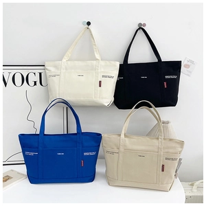 Detail showing high-capacity canvas tote bags in four colors with multi-pocket design