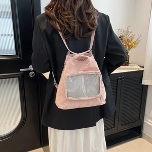 Pink nylon ita bag with transparent PVC window and adjustable straps for daily commute