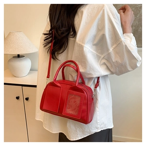 Stylish red Boston shoulder bag with dual functional front pockets shown on model