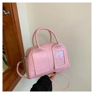 Detailed close-up of pink PU leather Boston bag with decorative window and dual top handles