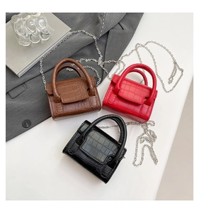 Detailed display of crocodile pattern mini handbags in brown, red, and black with chains