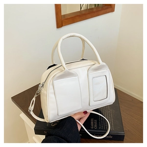 Creamy white bowling bag detail featuring front pockets and a transparent card slot