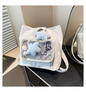 Detail of the white nylon ita bag with a clear PVC window and plush star charms