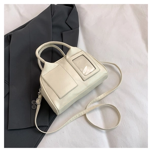 Close-up of cream PU leather Boston bag with square patch and transparent card slot