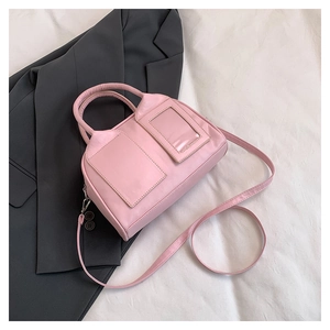 Detailed top view of a pink Boston bag with twin handles and a detachable shoulder strap