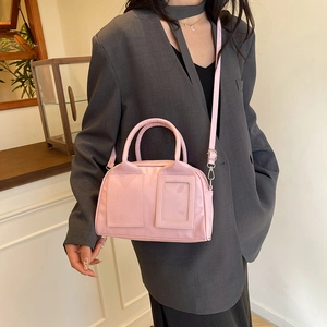 Pink Boston handbag for women styled with casual gray suit for a chic minimalist look