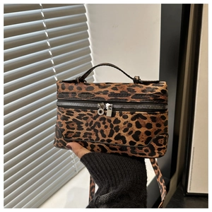 Detail of vintage leopard print box bag with silver zippers and textured leather