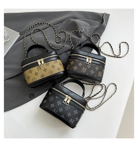 Detailed view of three mini chain bags with vintage monogram prints and gold hardware