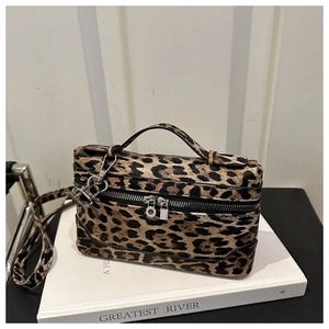 Detail of leopard print box bag featuring dual zippers, top handle, and detachable strap