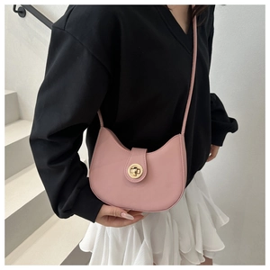 Detail of a pink crescent shoulder bag with golden metallic twist lock and smooth texture