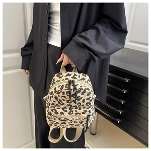 Close-up of leopard print corduroy mini backpack with durable black resin zippers