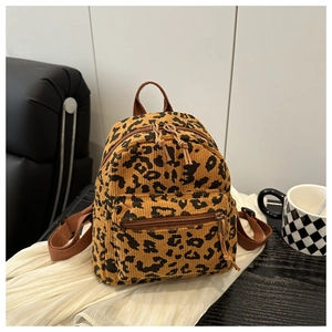 Detail of soft leopard print corduroy backpack with sturdy double zippers and brown straps