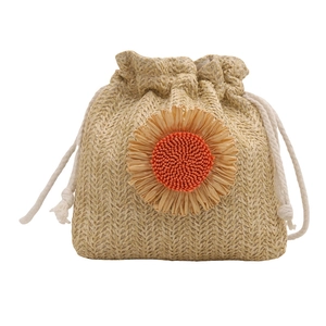 Woven straw bucket bag with floral accent and drawstring closure for summer beach style