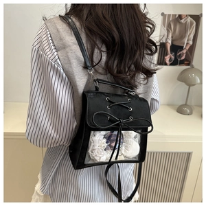 Close-up of a black ita bag with lace details and a transparent display window