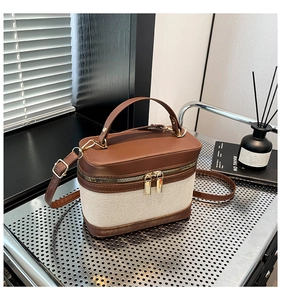 Détail du sac boîte bicolore marron et beige avec double fermeture éclair et anse