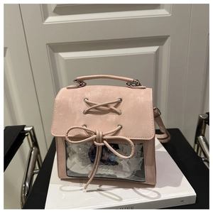 Pink ita bag detail featuring transparent PVC window with bow and lace decoration