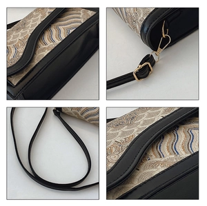 Detail of Chinese style crossbody bag showing wave pattern fabric and golden hardware